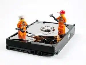 Lego workmen repairing a faulty hard drive